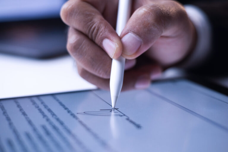 Close Up Businessman Hand Electronic Signature On Tablet By Styl