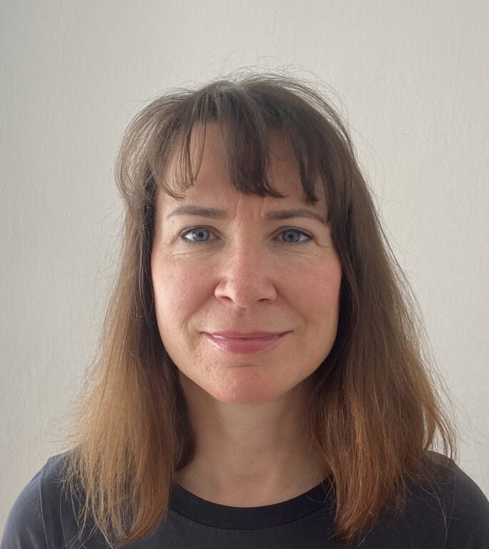 Iva Hendrych female with shoulder length brown hair and green eyes
